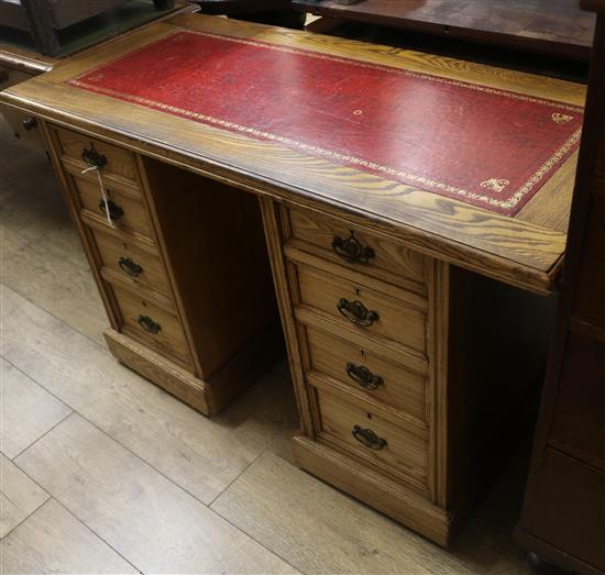 An Edwardian oak pedestal desk W.125cm